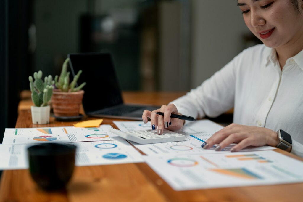 Business woman using calculator for tax, accounting, statistics and analytic research concept.